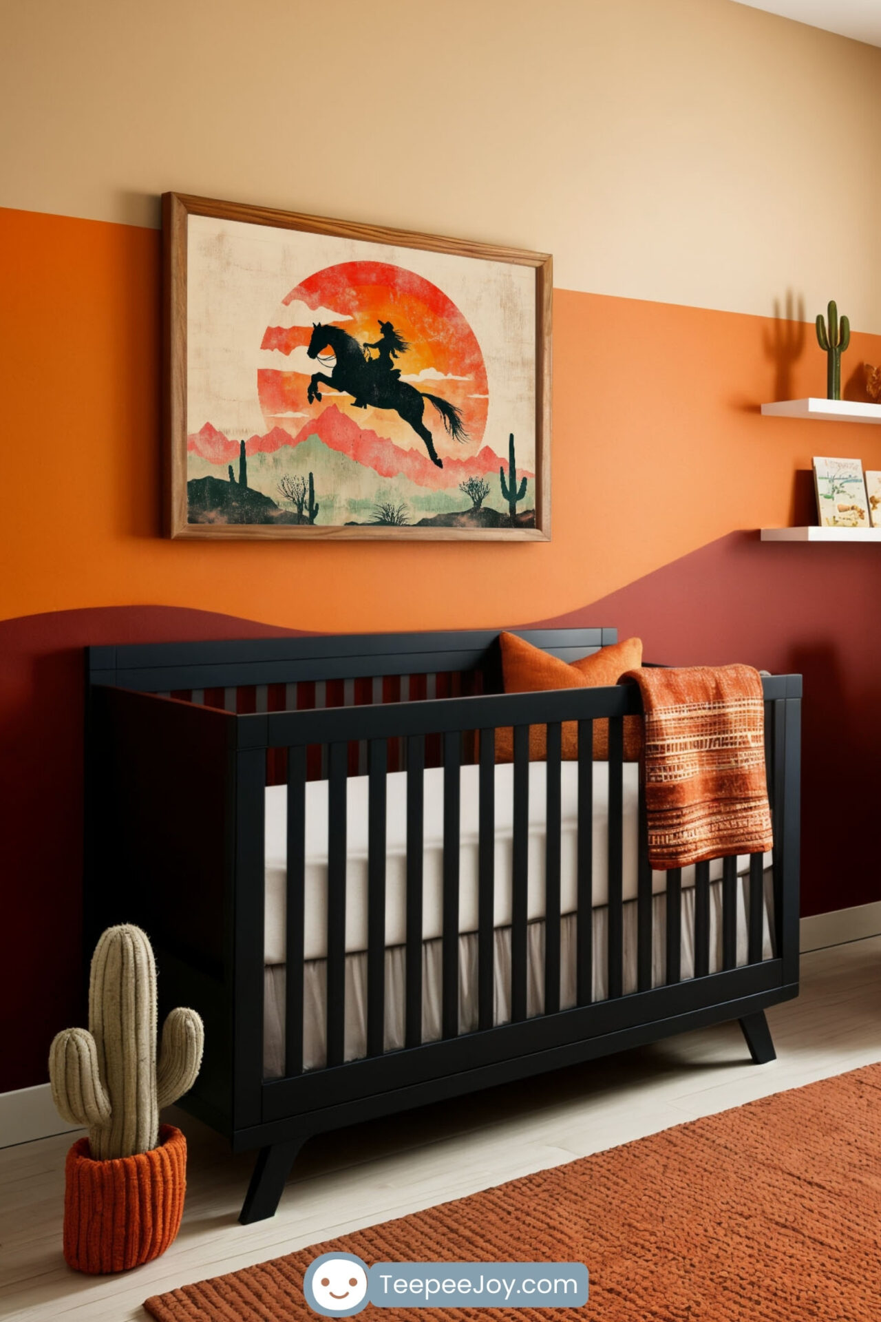 This image presents a western-themed nursery with warm, earthy tones and a bold design. The focal point is a framed artwork of a cowgirl riding a horse against a vivid sunset backdrop, mounted on a two-tone accent wall in desert-inspired hues. The room features a black crib with an orange throw, a soft cream armchair with a matching pillow, and playful decor such as a cactus planter and a rocking horse. A textured orange rug and natural light enhance the cozy and adventurous atmosphere.