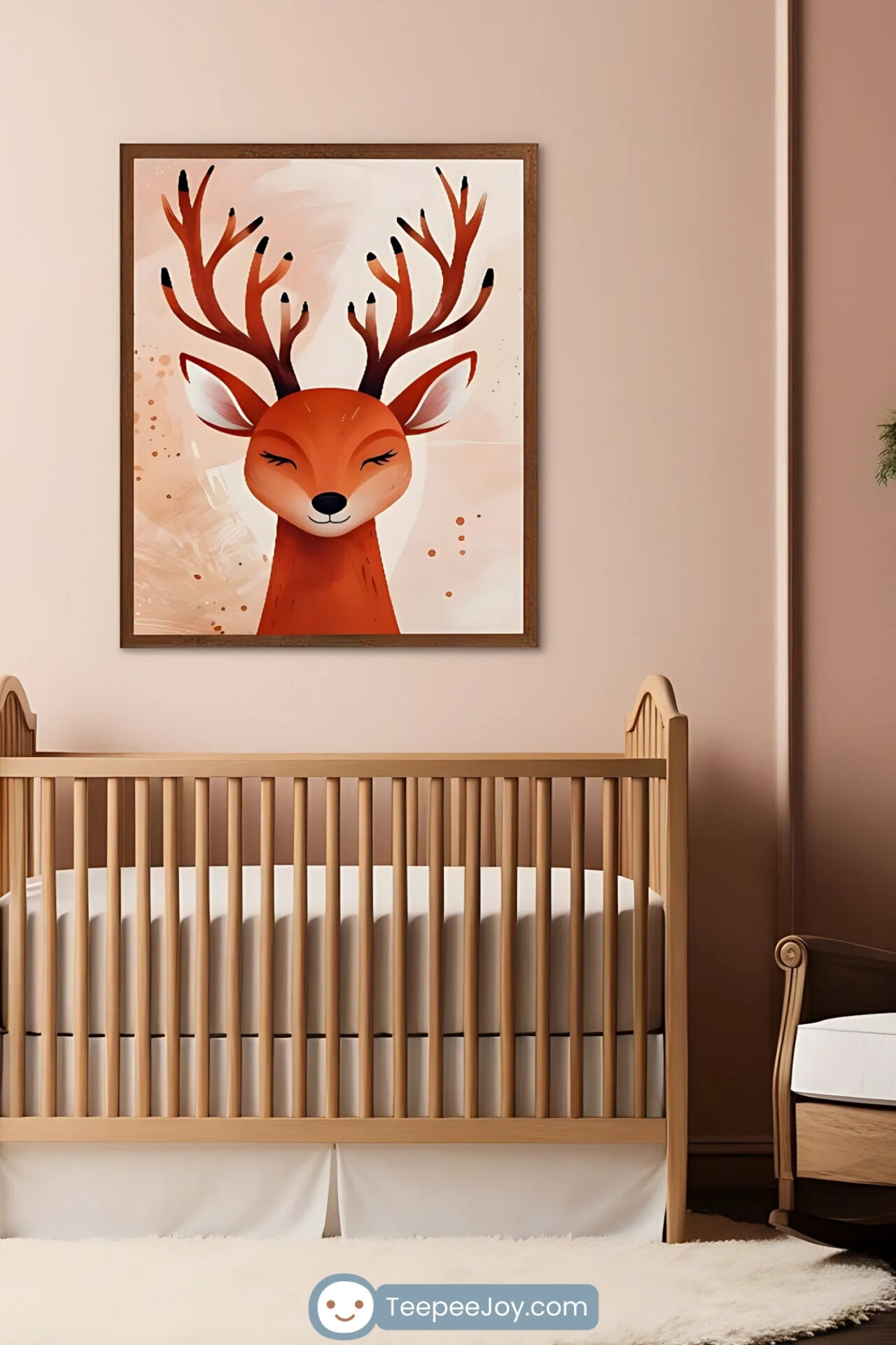 This image depicts a beautifully designed nursery with a warm and natural aesthetic. The focal point is a framed illustration of a peaceful deer with large antlers, hung on a soft peach wall above a wooden crib. The space is styled with hanging greenery, a woven basket with blankets, and a cozy white rug, creating a charming and tranquil atmosphere.