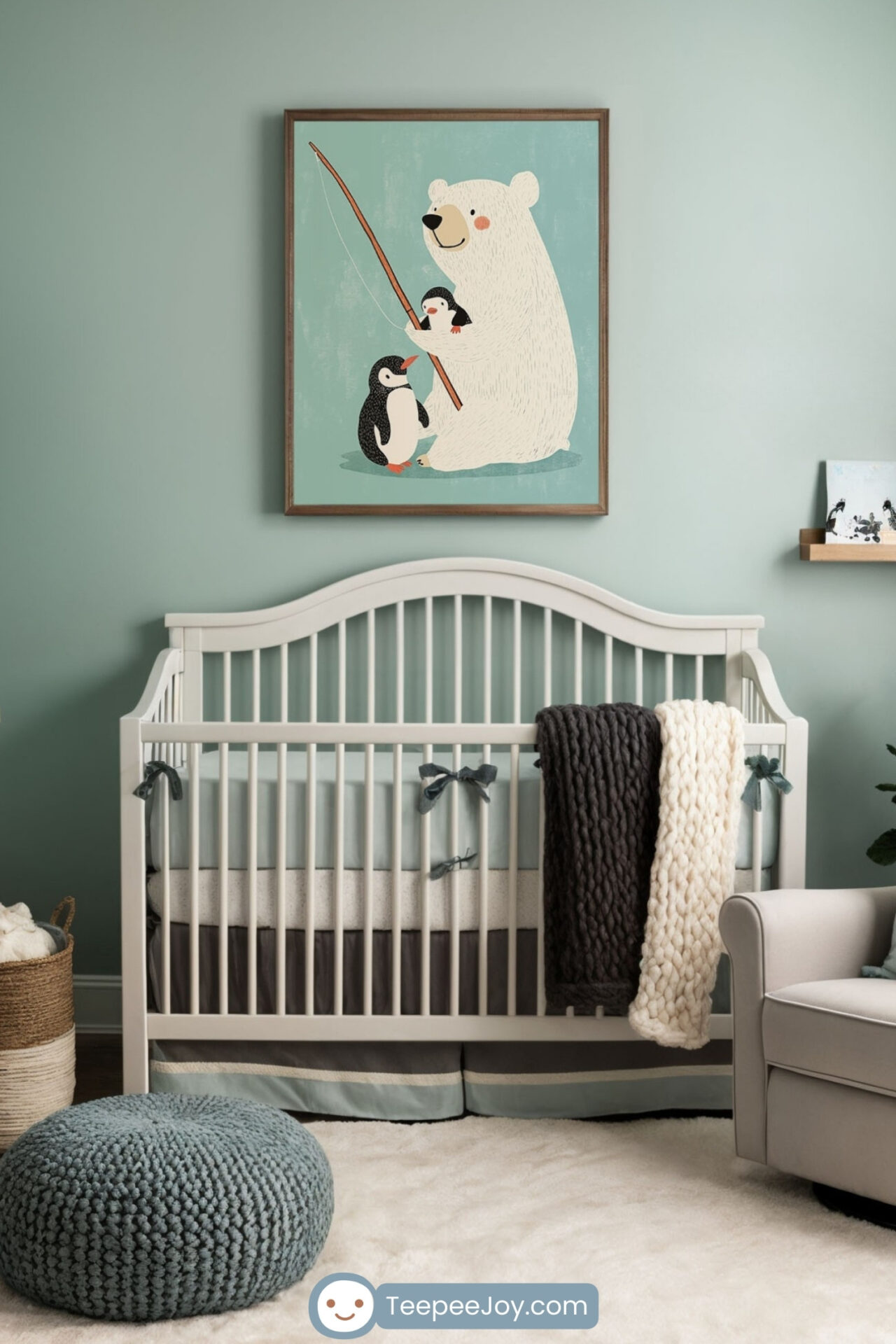 Cozy nursery with muted green walls, featuring a framed illustration of a polar bear and penguins fishing above a white crib. The room is decorated with a wooden dresser, a plush armchair with a chunky knit blanket, and a round knitted ottoman. A soft white rug, a small shelf with books, and a potted plant add warmth and charm to the space.