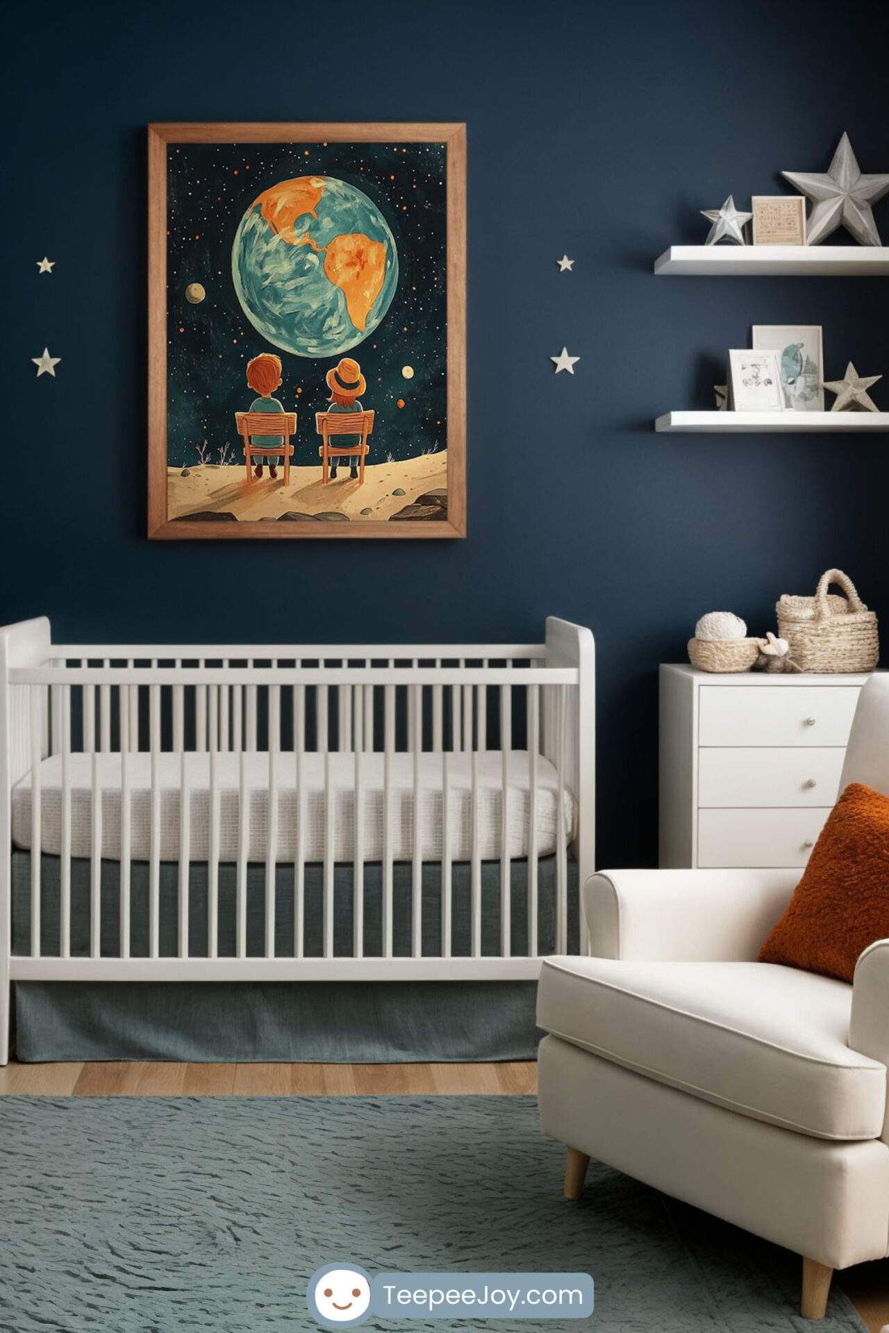 Cozy nursery with a space-themed design. A framed painting of two children sitting on a moon-like surface, gazing at Earth, hangs on a navy blue accent wall above a white crib. The room is decorated with soft neutrals, including a plush white armchair with an orange accent pillow, a light wood dresser, a green potted plant, and floating shelves with star-shaped ornaments and books, creating a warm and inviting atmosphere.